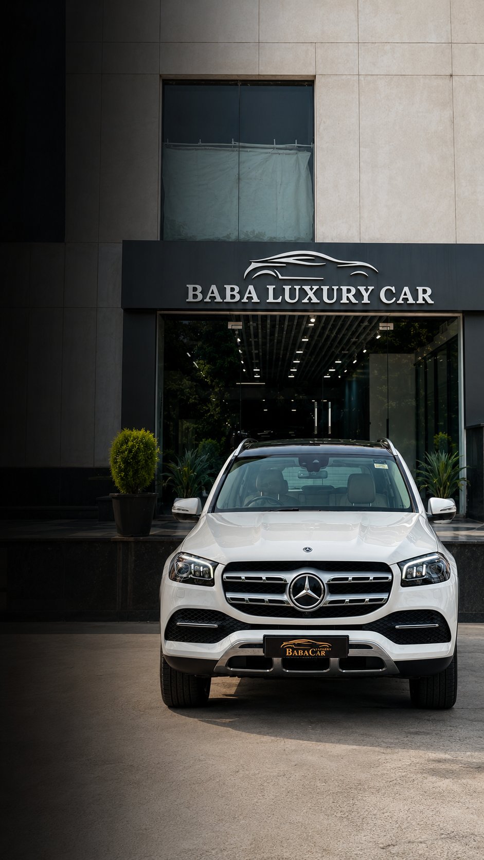 Baba Luxury Car showroom entrance with a white Mercedes-Benz GLS at Emaya Mall, Paschim Vihar, New Delhi.
